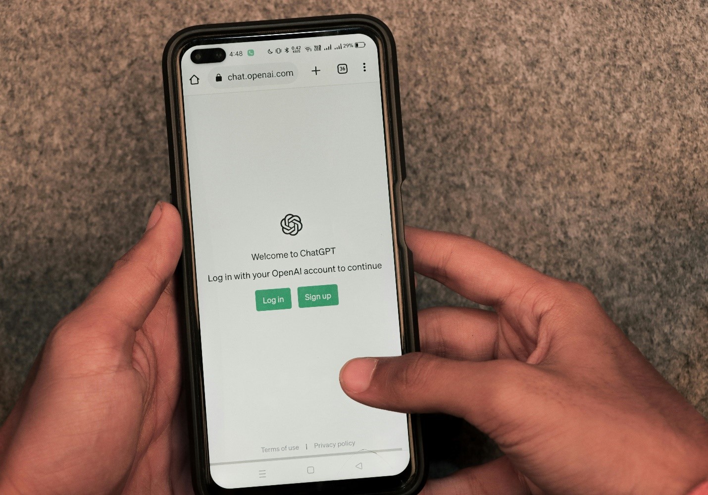 A person holding a mobile phone open to ChatGPT